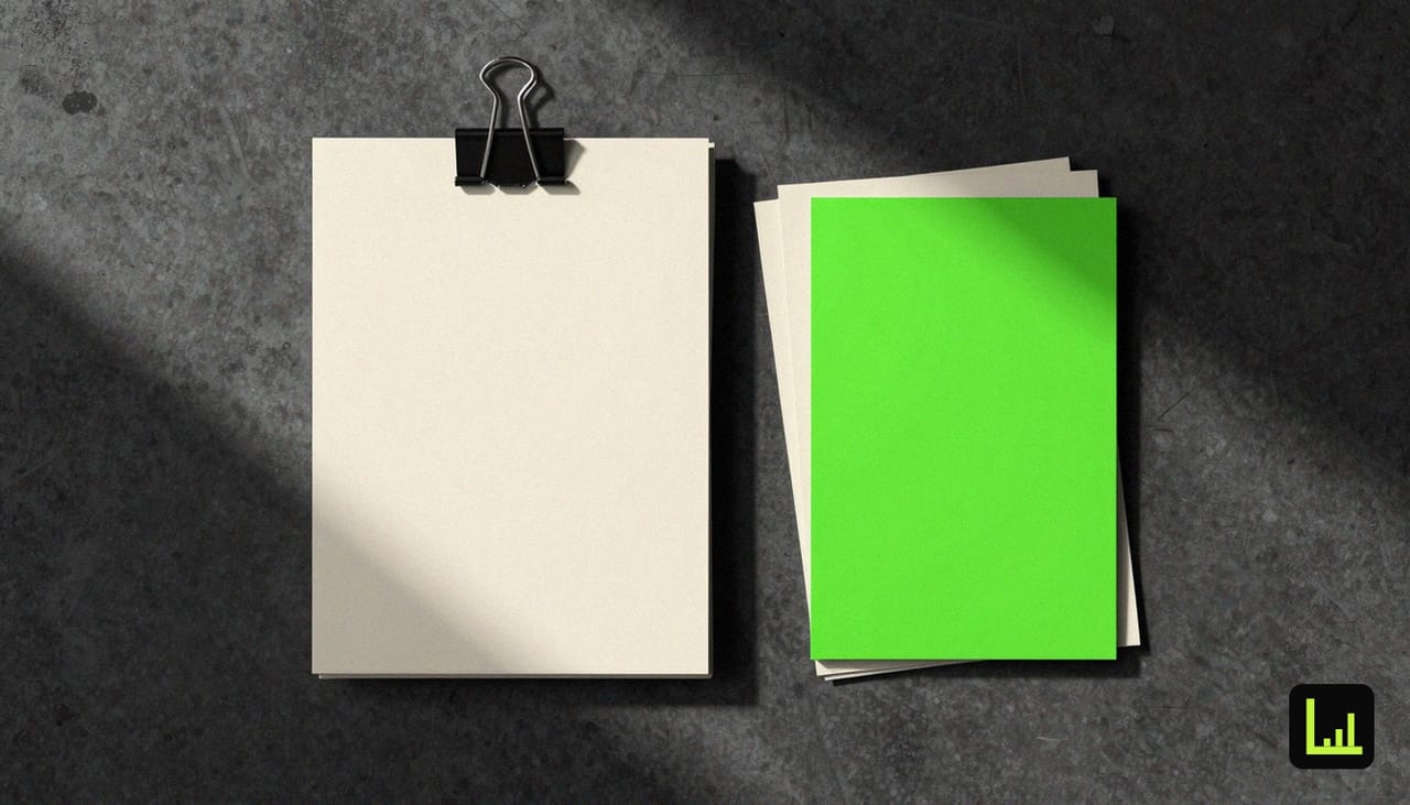 A clipped stack of blank cream forms beside a bold lime-green card on dark concrete, the scoring step that follows the agency client intake template.